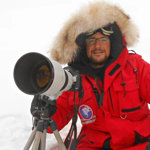 Marco Gaiotti the award winning wildlife photographer is pictured here with his camera and tripod during an expedition to the arctic. Marco is a wildlife photography tour guide for Nature Talks in the UK.