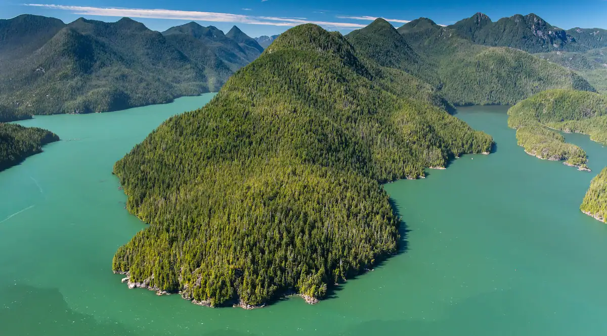 Aerial view of forested islands and turquoise waterways in Clayoquot Sound near Tofino, British Columbia, photographed by Garth Lenz.